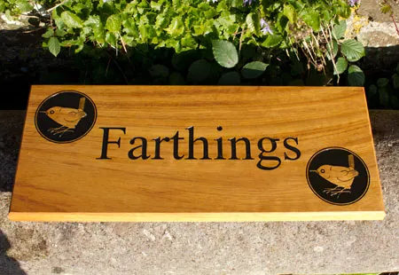 Iroko is an east timber to maintain A beautiful Iroko wood house sign with the farthing image on it.