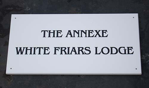 Engraved white corian for a very smart house sign. Engraved White Corian.