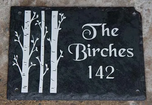 Interesting design on a rustic slate house sign. Rustic Slate Sign