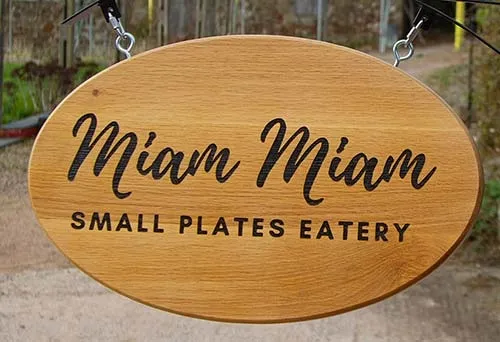 This oval wooden sign was attached to a hanging bracket. Oval Wooden Sign