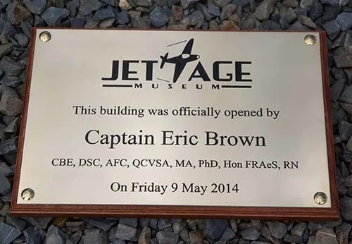 Engraved brass business sign on a backing board Engraved Brass Sign